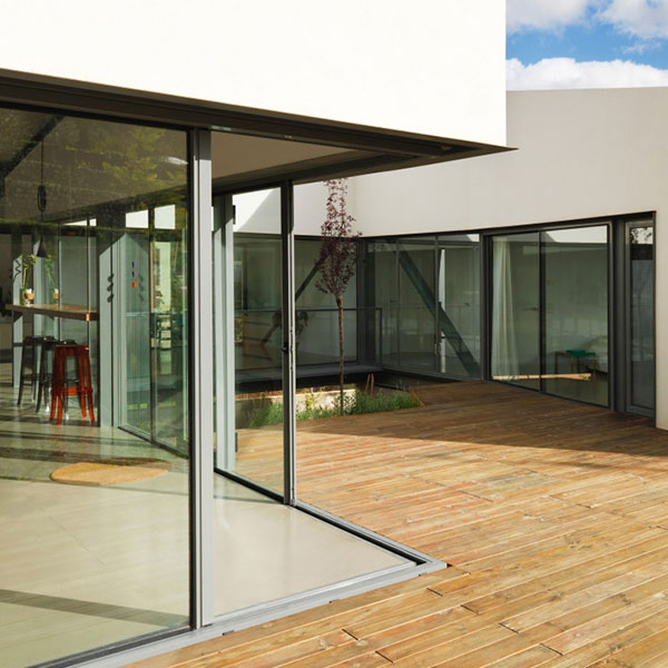 wooden decking with small tree surrounded by patio doors