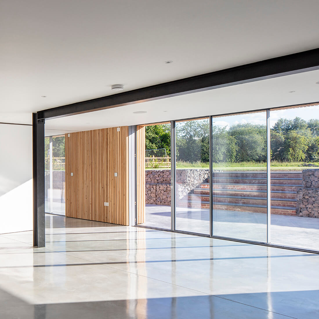 Aluminium Sliding Doors with steps and bushes in background