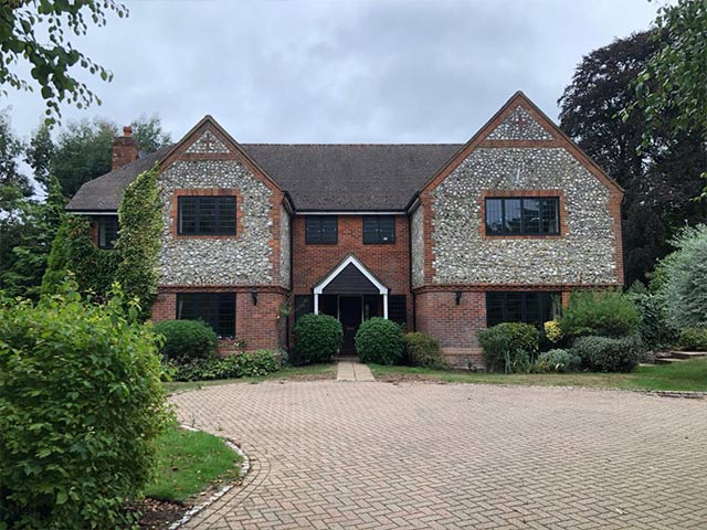 double fronted house with feature stonework and driveway